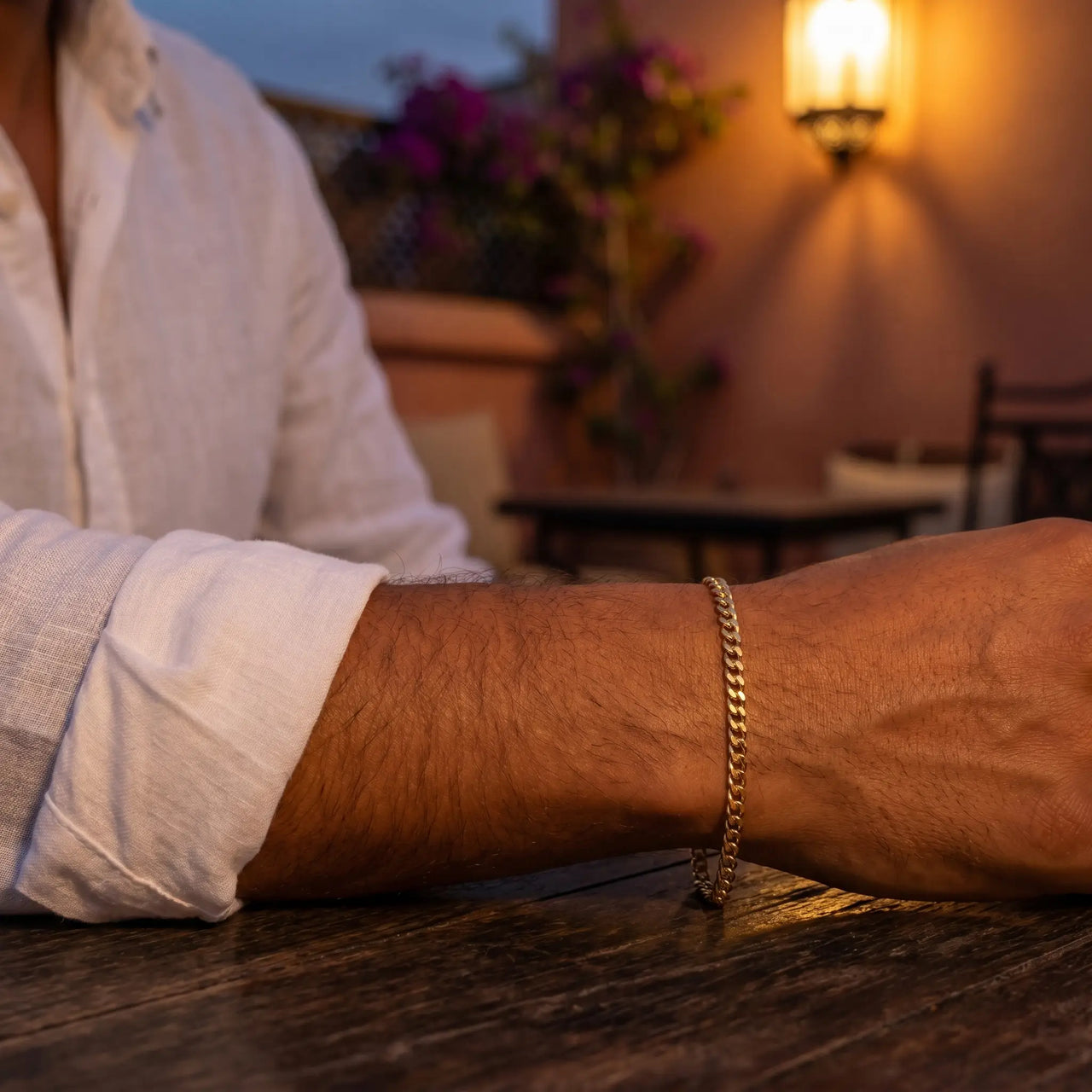 Maghrebin man wearing His gold cuban Heart Bond bracelet, Marrakech rooftop dusk