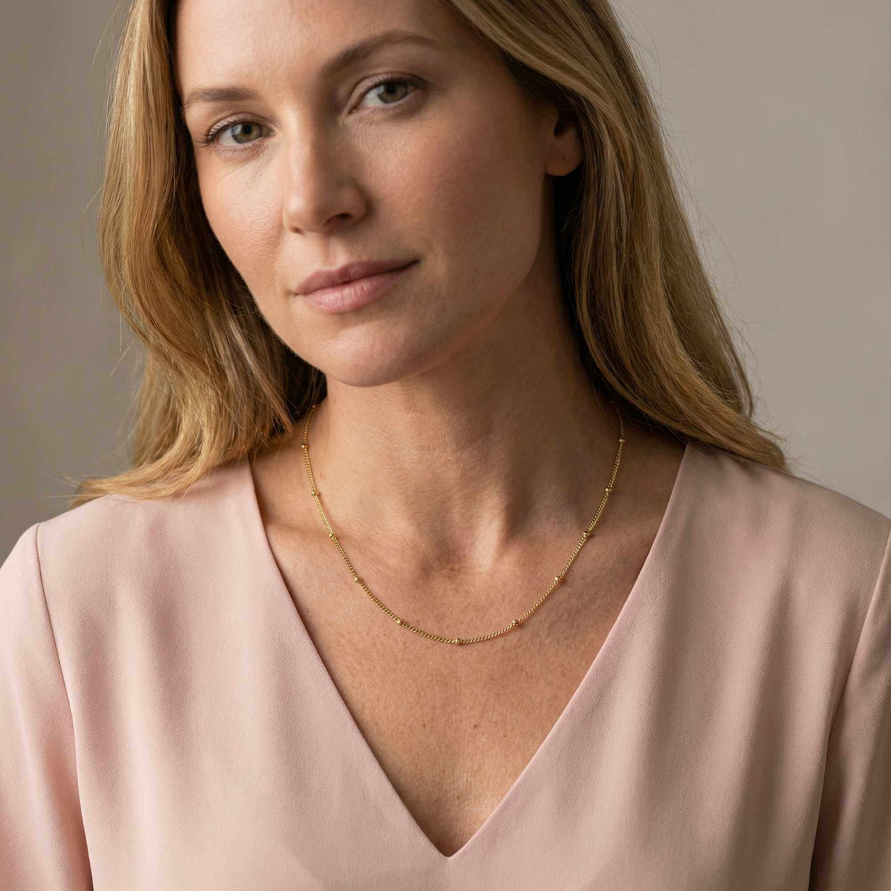 Julia Beaded Chain Necklace by Brother & Sisters, featuring a delicate gold bead chain elegantly worn.