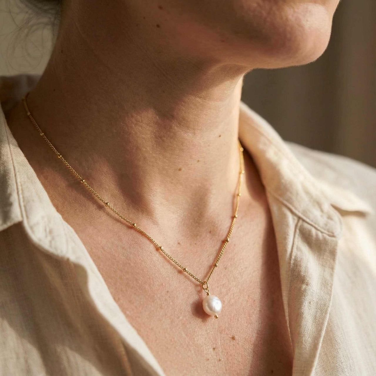 Pearl Drop Necklace worn elegantly, featuring an 8mm freshwater baroque pearl by Brother & Sisters.
