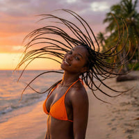 Thumbnail for Woman in orange bikini with braided hair enjoying the beach at sunset.