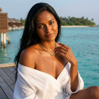 Thumbnail for Model wearing Vali Heart Choker Necklace by Brother & Sisters, enjoying a sunny beach setting.