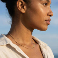 Thumbnail for Julia Beaded Chain Necklace worn by a woman, featuring a whisper-thin chain with golden beads by Brother & Sisters.
