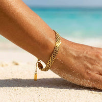 Thumbnail for Sifnos Woven Bracelet elegantly worn on the beach, showcasing premium stainless steel and 18K gold PVD, by Brother & Sisters.