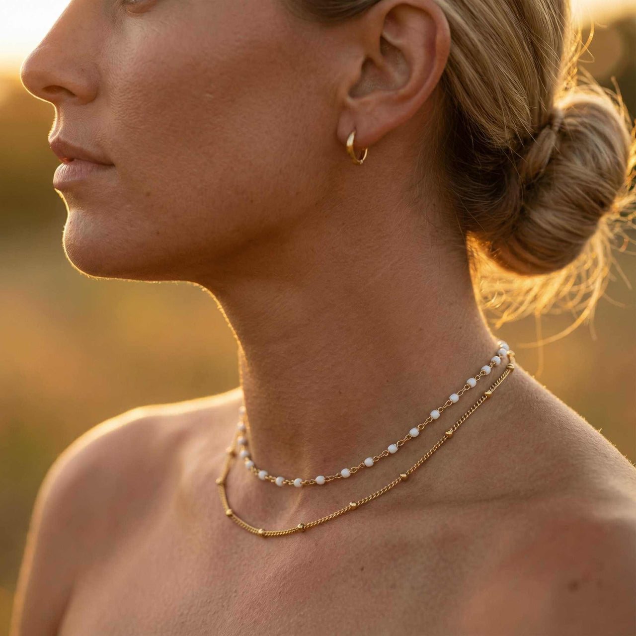 Double Layer Choker featuring white enamel beads and gold satellite chain by Brother & Sisters, layered elegance.