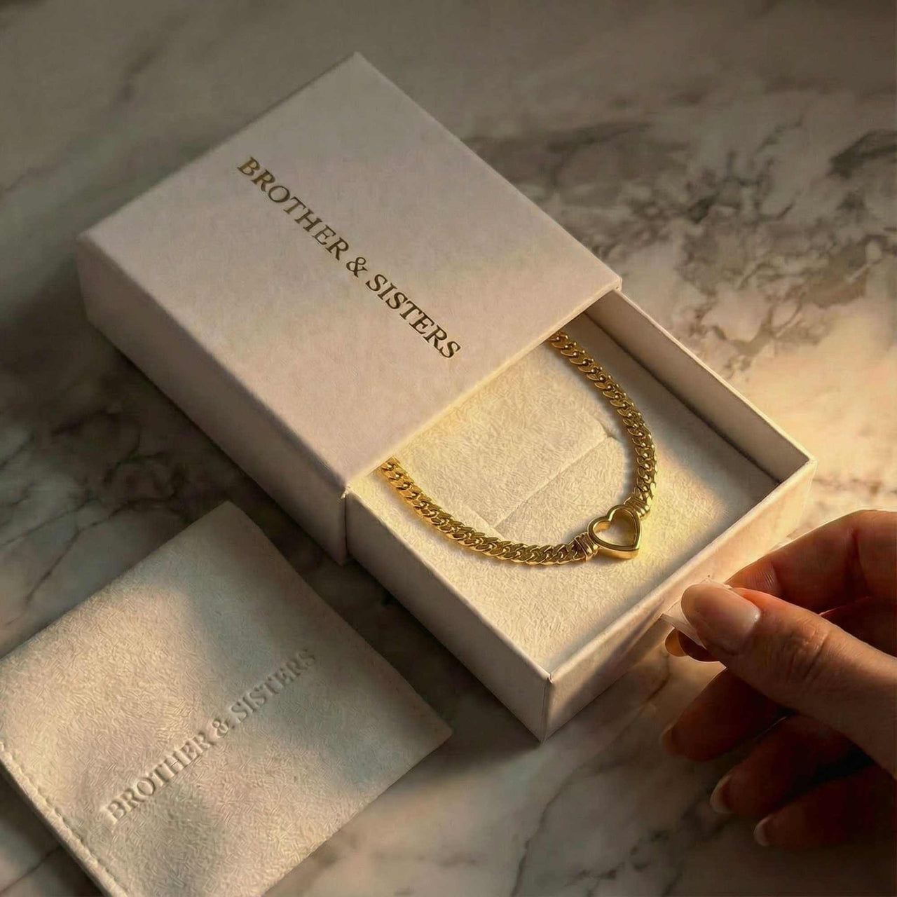 Vali Heart Choker Necklace presented in a Brother & Sisters box, showcasing its chunky Cuban chain and heart design.