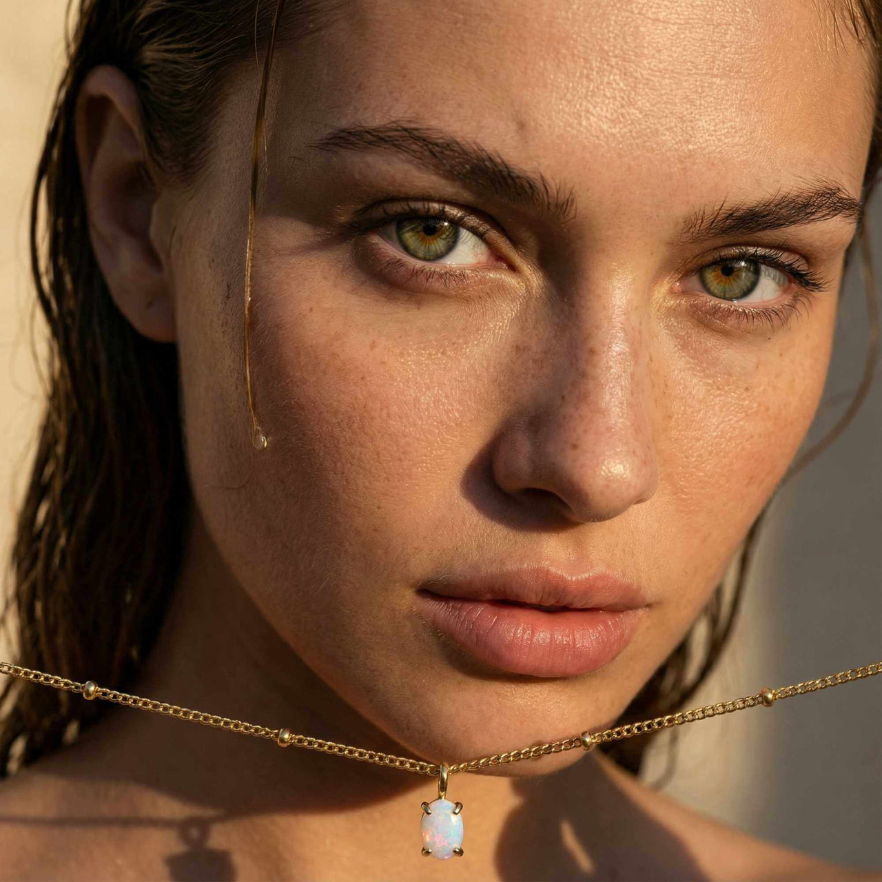 Opal Pendant Necklace featuring a stunning AAA-grade opal set in gold, by Brother & Sisters, worn on a delicate satellite chain.