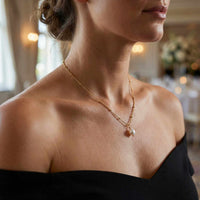 Thumbnail for Woman wearing a Pearl Drop Necklace by Brother & Sisters, featuring a freshwater baroque pearl on a textured chain.