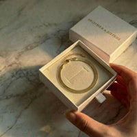 Thumbnail for Kauai Herringbone Bracelet in a Brother & Sisters box, showcasing sleek herringbone design and gold shimmer.