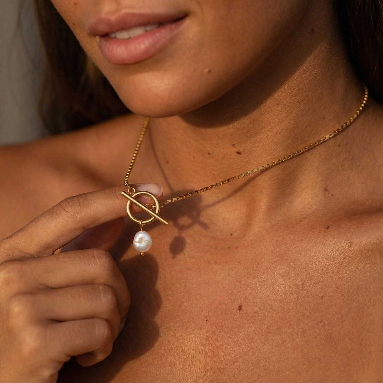 La Isla Pearl Toggle Necklace featuring a sculptural gold clasp and a freshwater pearl by Brother & Sisters.