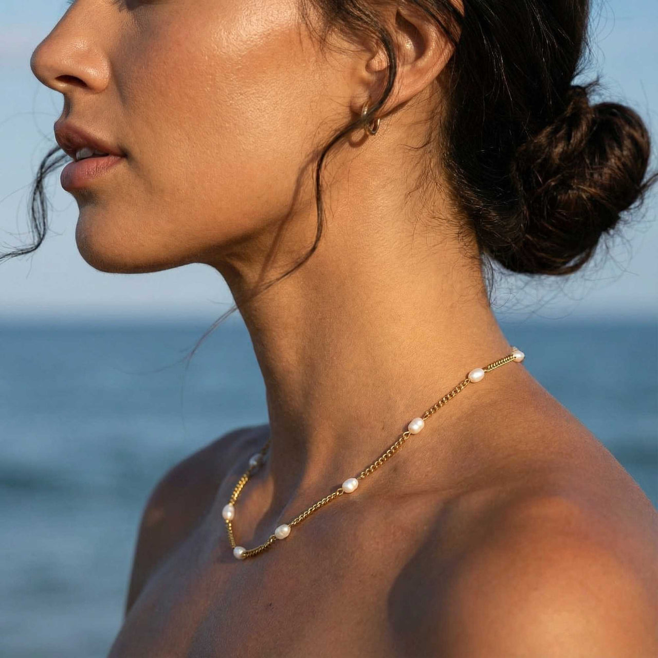 Dainty Pearl Choker worn by a model, featuring tiny freshwater pearls on a delicate gold chain by Brother & Sisters.