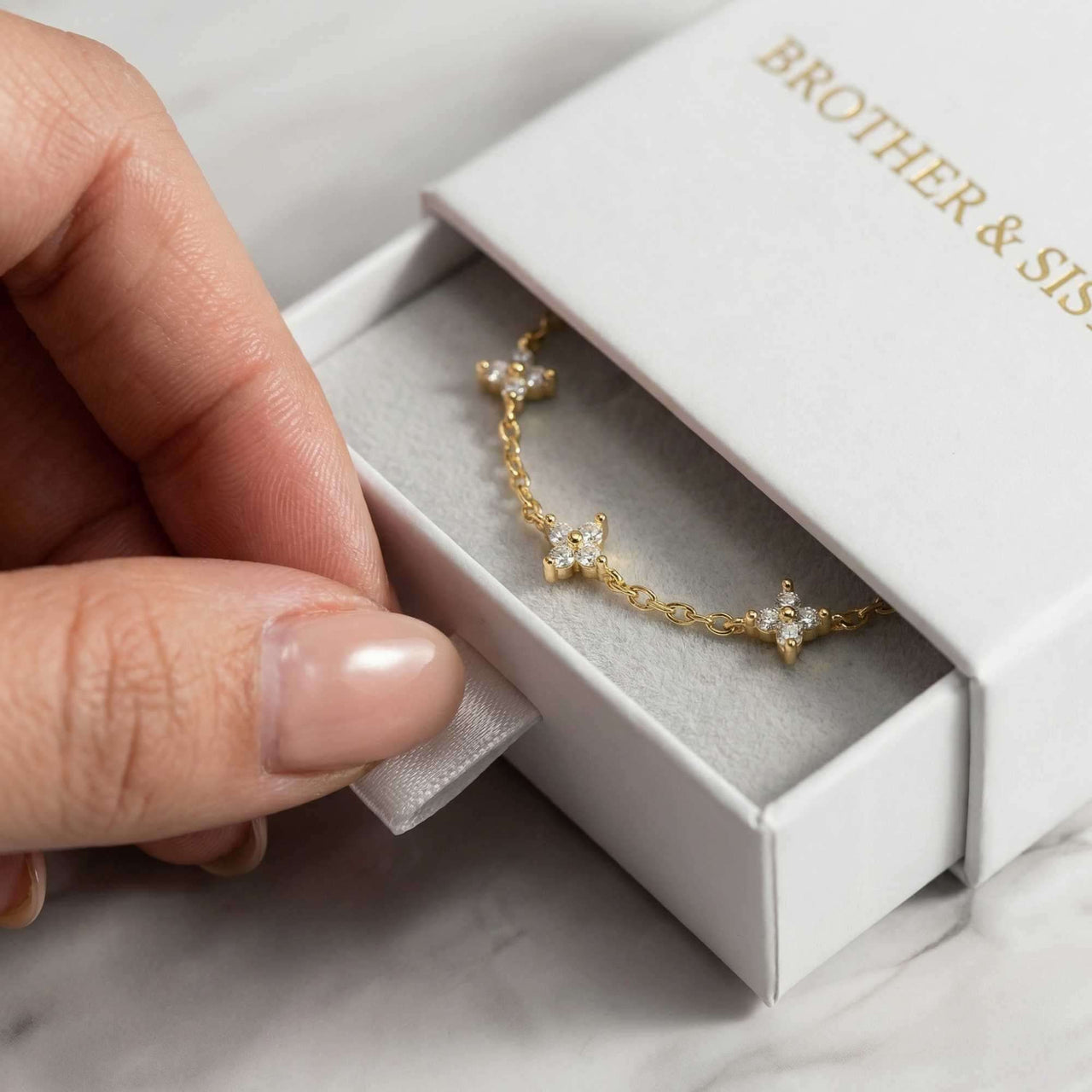 Crystal Flower Bracelet by Brother & Sisters, featuring five crystal flowers in a gift box.