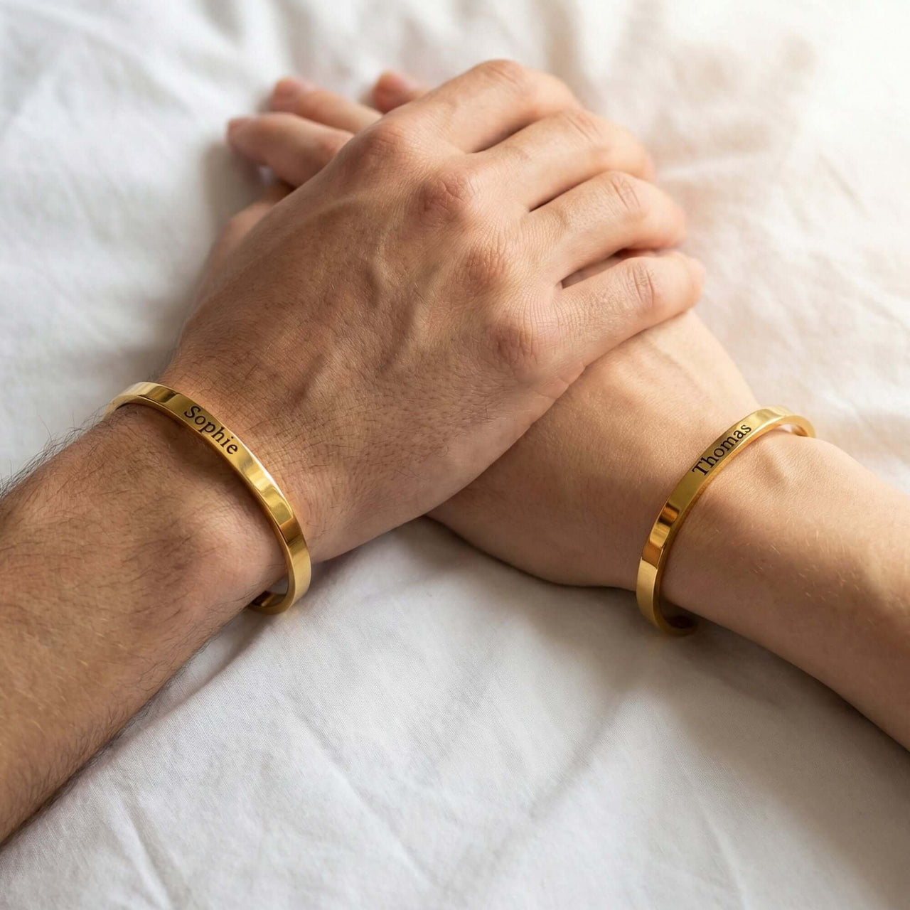 Matching Couple Bracelet showcasing gold cuffs engraved with names Sophie and Thomas by Brother & Sisters.