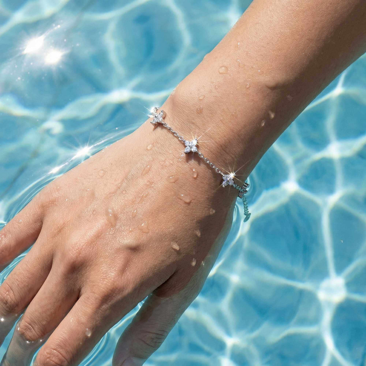 Crystal Flower Bracelet by Brother & Sisters, featuring five sparkling crystal flowers on a delicate chain.