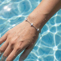 Thumbnail for Crystal Flower Bracelet by Brother & Sisters, featuring five sparkling crystal flowers on a delicate chain.