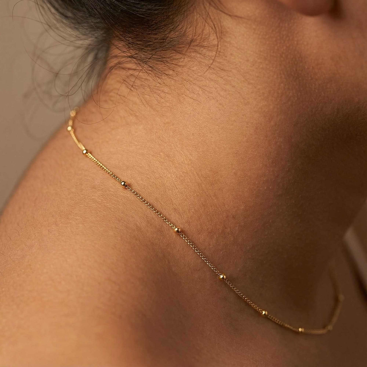 Julia Beaded Chain Necklace worn elegantly, featuring tiny golden beads for an understated look by Brother & Sisters.
