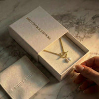 Thumbnail for La Isla Pearl Toggle Necklace in a Brother & Sisters box with a gold toggle and freshwater pearl.