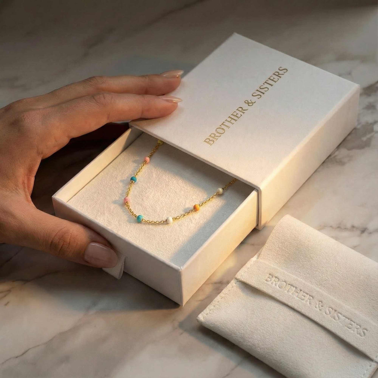 Rainbow Choker by Brother & Sisters in a gift box, showcasing colorful enamel beads and elegant packaging.
