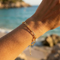 Thumbnail for Freshwater Pearl Bracelet on a wrist, featuring unique pearls and a golden-hour beach backdrop by Brother & Sisters.