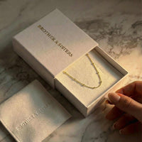 Thumbnail for Julia Beaded Chain Necklace displayed in a Brother & Sisters gift box, showcasing its elegant design and golden beads.
