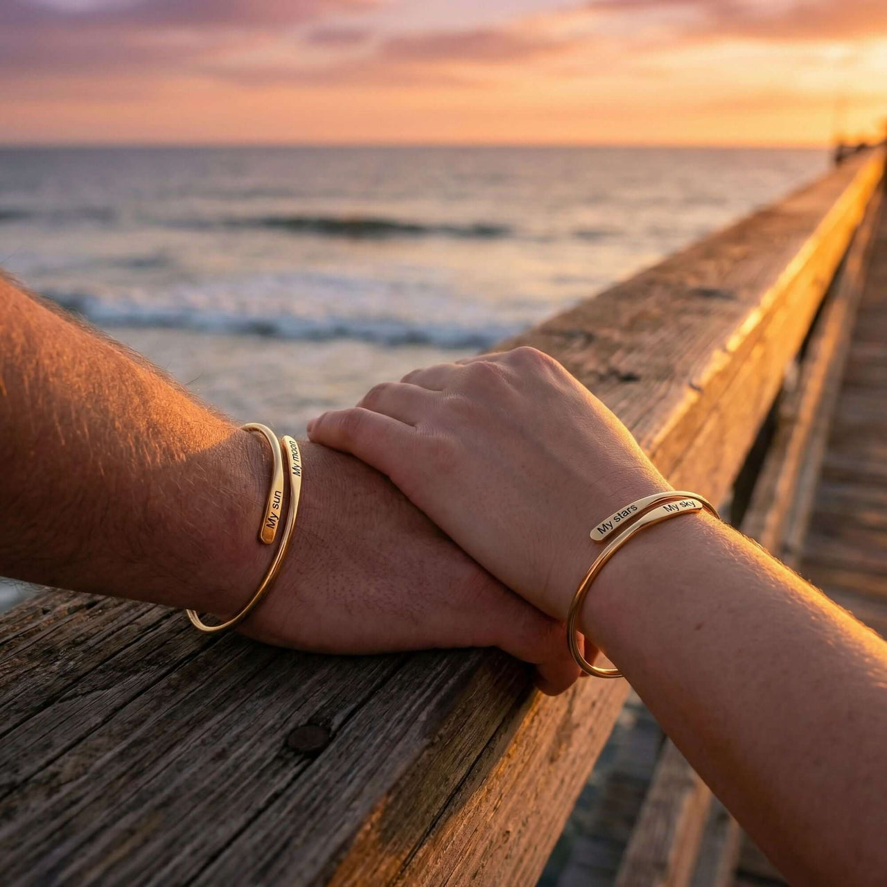 Wrap Couple Bracelet by Brother & Sisters featuring personalized engravings held by couple at sunset.