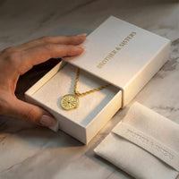 Thumbnail for Golden Sun Necklace in a Brother & Sisters gift box, showcasing the sun medallion and classic rope chain.