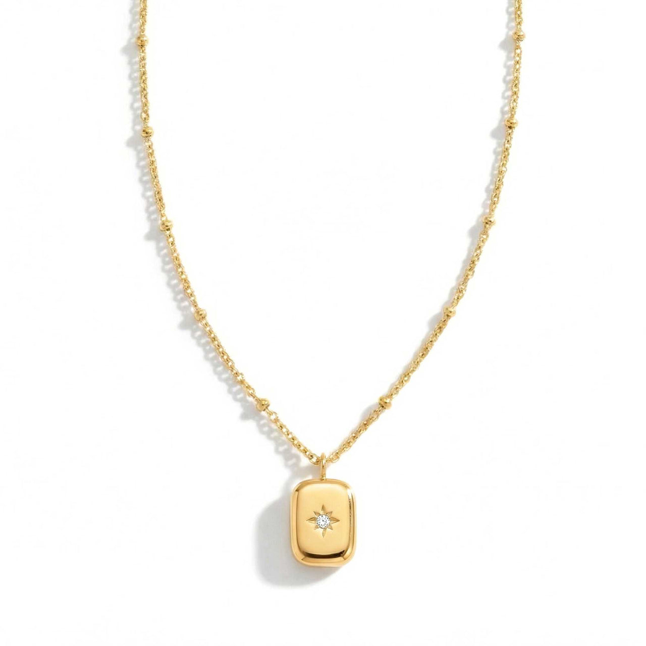 Starlight Pendant Necklace by Brother & Sisters, gold tag pendant with zirconia stone, vintage medallion style.