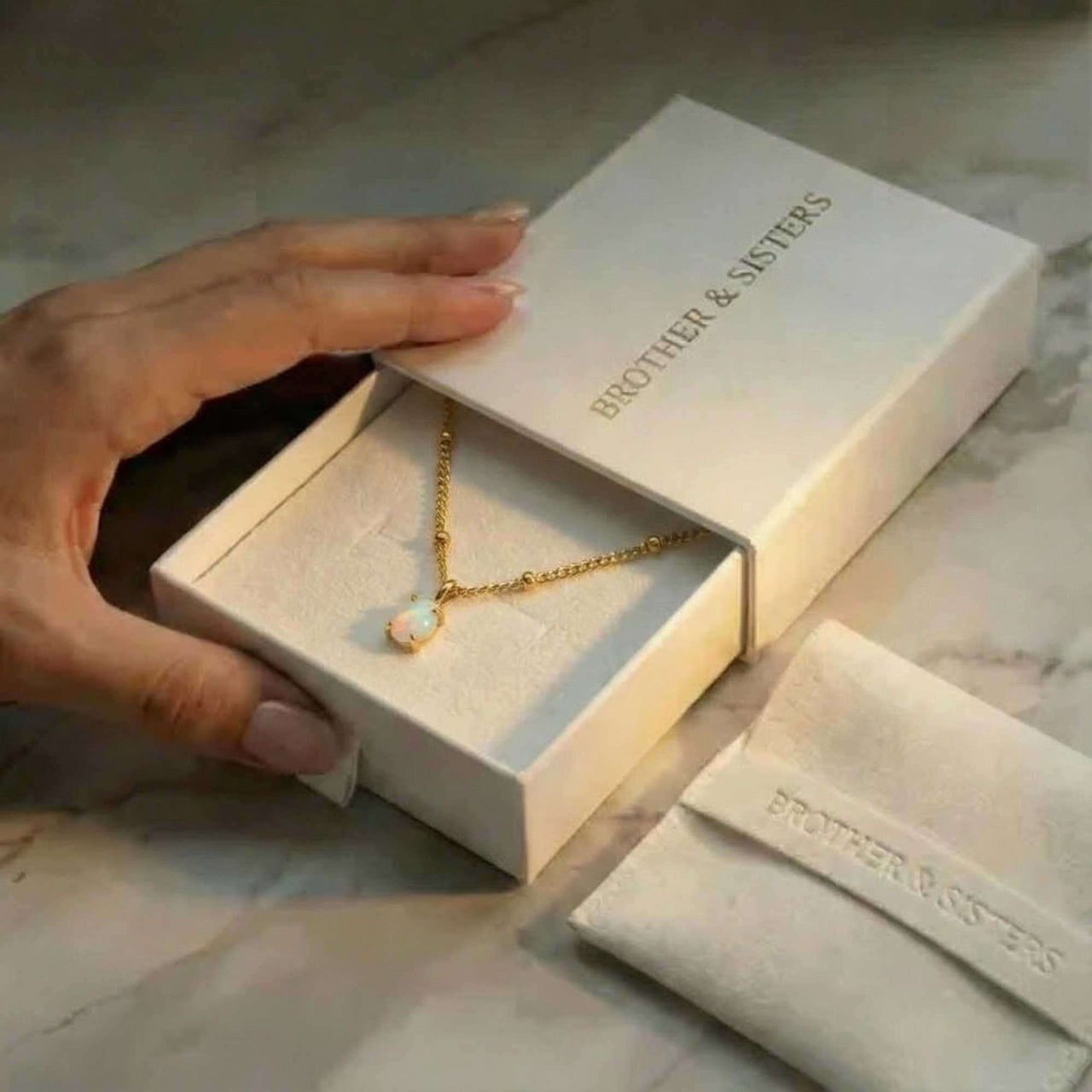 Opal Pendant Necklace in a Brother & Sisters gift box, showcasing the stunning design and delicate chain.