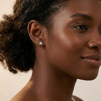 Thumbnail for Model wearing Crystal Flower Stud Earrings by Brother & Sisters, featuring tiny flower design with sparkling zirconia.
