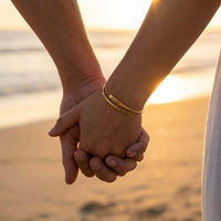 Thumbnail for Wrap Couple Bracelet engraved with two names symbolizing love, featured by Brother & Sisters in sunset background.