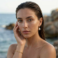 Thumbnail for Freshwater Pearl Bracelet showcased by a model against a beach backdrop, featuring unique handcrafted pearls by Brother & Sisters.