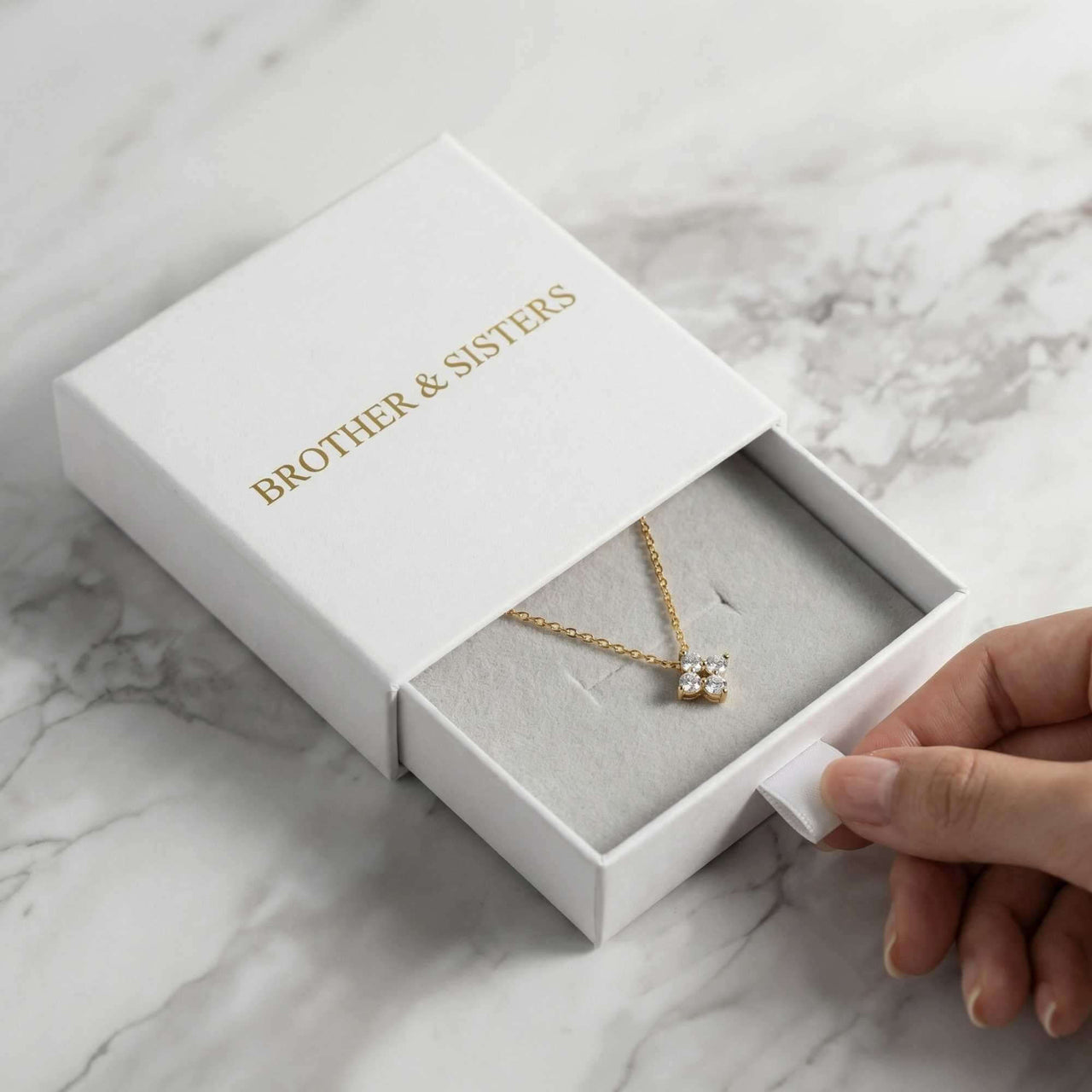 Crystal Flower necklace in Brother & Sisters signature white slide-drawer gift box — dainty pendant gift packaging