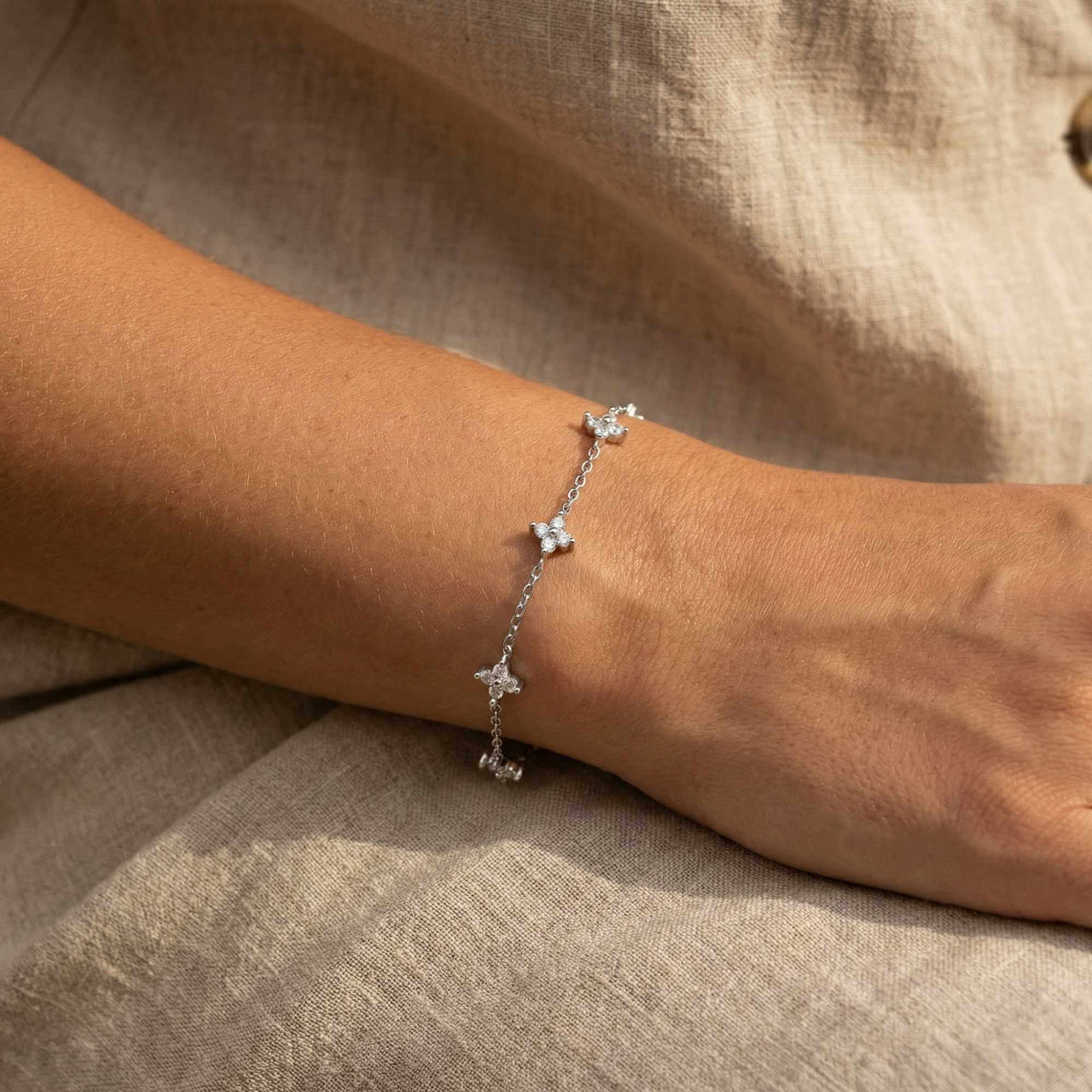 Crystal Flower Bracelet by Brother & Sisters features five delicate crystal flowers on a fine chain.