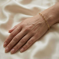 Thumbnail for Hand wearing a Paperclip Chain Bracelet by Brother & Sisters, featuring simple links and premium stainless steel with gold finish.