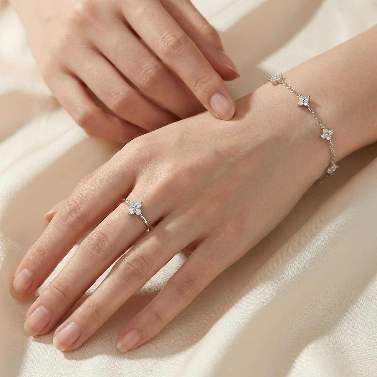 Crystal Flower Ring worn on a hand, featuring zirconia stones and delicate silver design by Brother & Sisters.