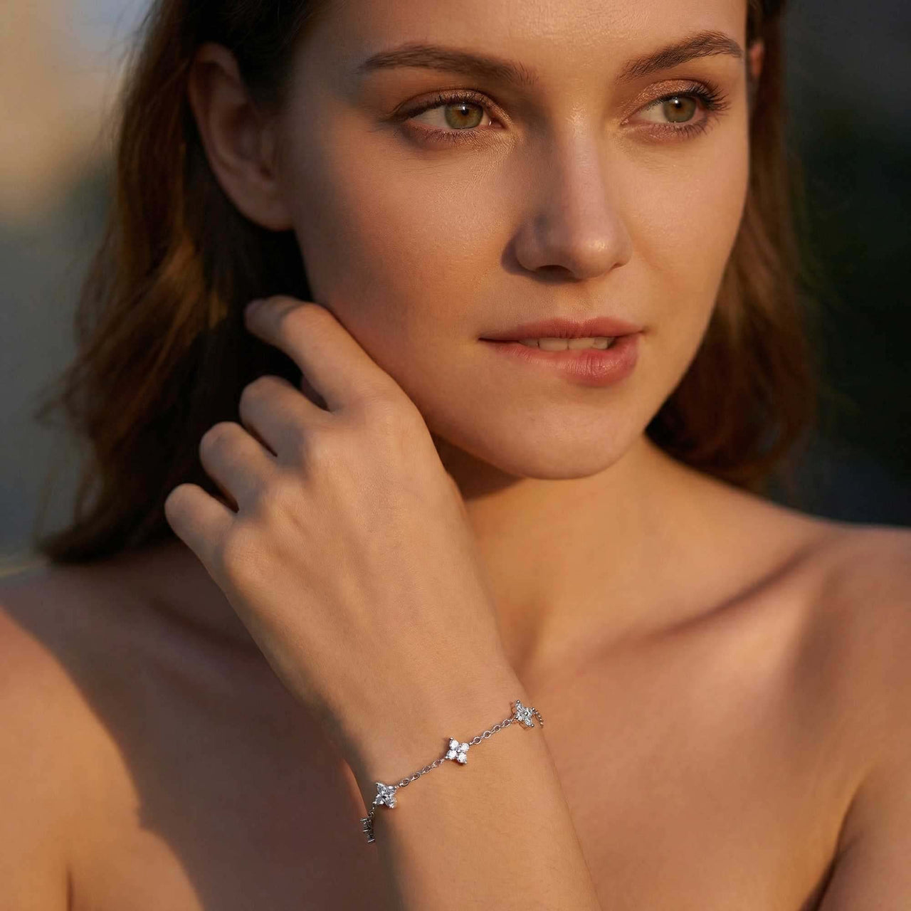 Crystal Flower Bracelet by Brother & Sisters featuring five delicate crystal flowers on a woman's wrist.