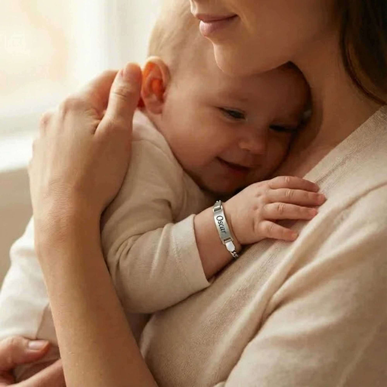 Infant Bracelet worn by a smiling baby, personalized, soft, and elegant keepsake from Brother & Sisters.