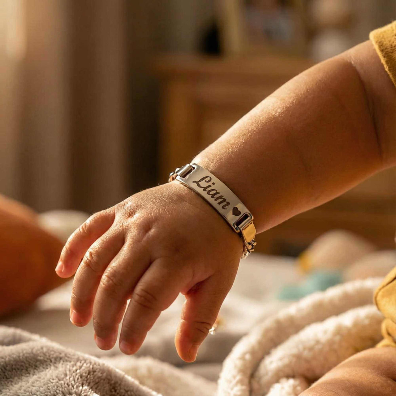 Infant Bracelet with personalized name 'Liam' by Brother & Sisters, perfect keepsake for baby.