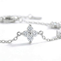 Thumbnail for Crystal Flower Bracelet by Brother & Sisters featuring five sparkling four-leaf crystal flowers on a delicate chain.