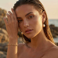 Thumbnail for Paperclip Chain Bracelet worn by a model with a natural background, featuring premium stainless steel and 18K gold PVD coating.