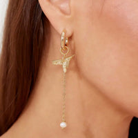 Thumbnail for Celeste Charm Hoops by Brother & Sisters featuring a hummingbird and faux pearl design in gold.