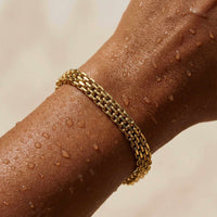Thumbnail for Sifnos Woven Bracelet on a hand with water droplets, showcasing its premium gold mesh design from Brother & Sisters.