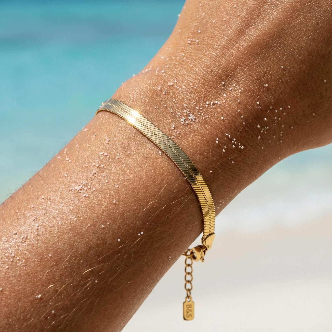 Kauai Herringbone Bracelet by Brother & Sisters, showcasing a sleek herringbone chain with 18K gold PVD coating.