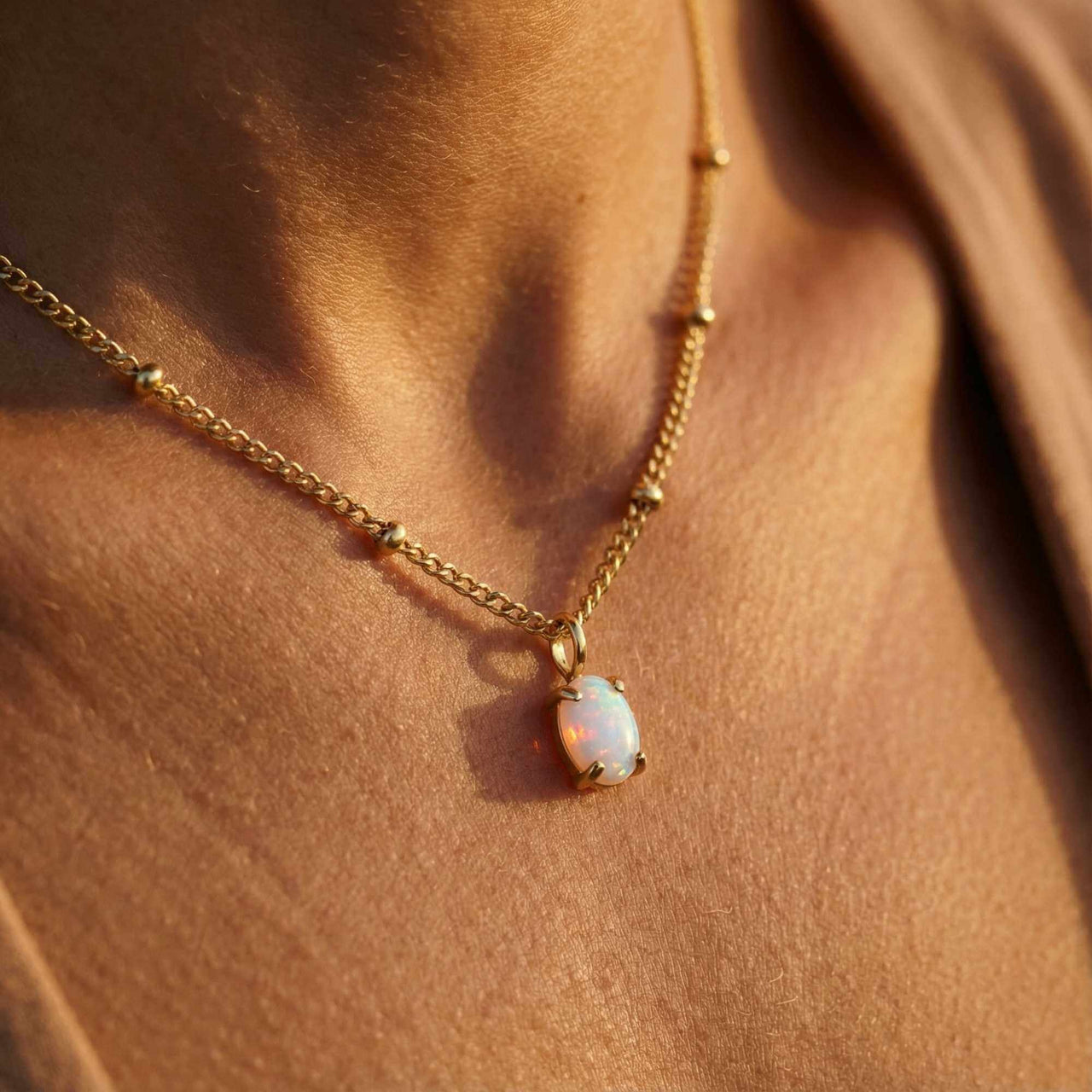Opal Pendant Necklace by Brother & Sisters, featuring AAA-grade opal in gold prongs on a delicate satellite chain.