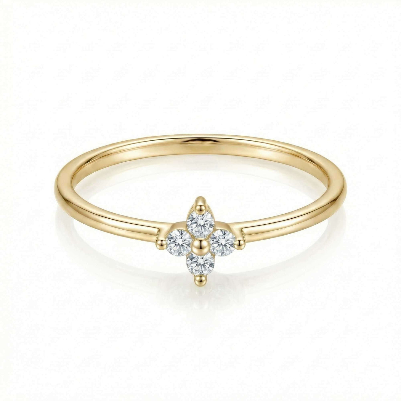 Crystal Flower Ring by Brother & Sisters features a delicate gold band with zirconia stones in a four-leaf flower design.