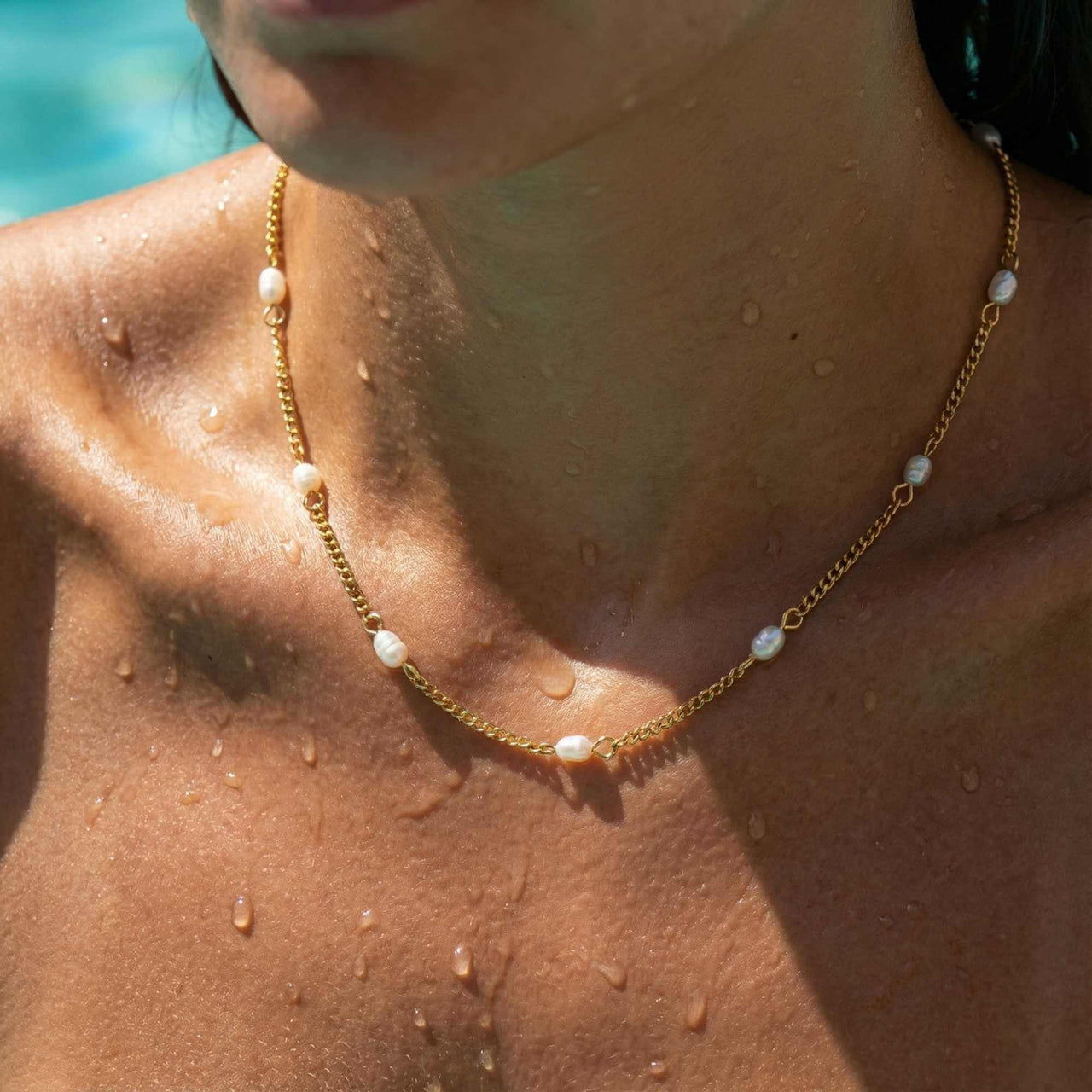 Dainty Pearl Choker worn by a woman, featuring tiny freshwater pearls and a delicate gold chain by Brother & Sisters.