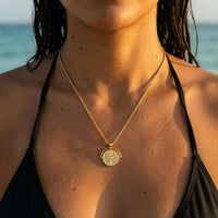 Thumbnail for Golden Sun Necklace worn on a model, featuring a sun medallion pendant by Brother & Sisters, on a rope chain.
