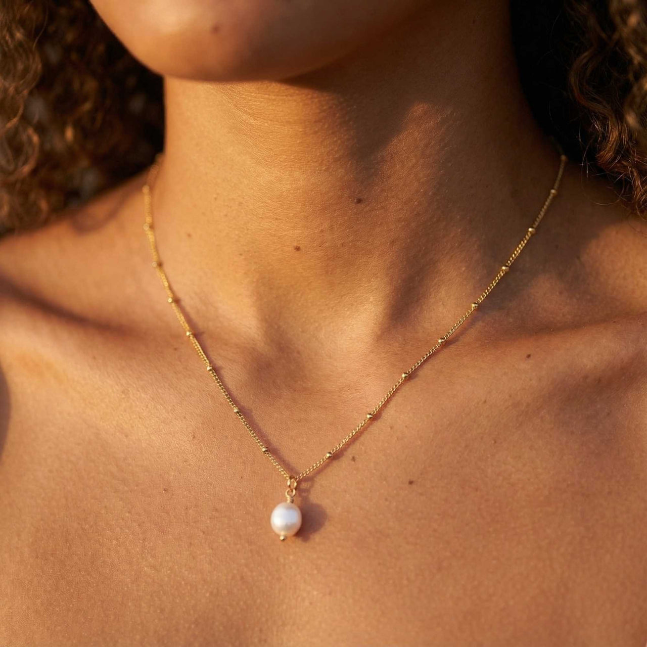 Pearl Drop Necklace by Brother & Sisters featuring a lustrous baroque pearl on a textured satellite chain.