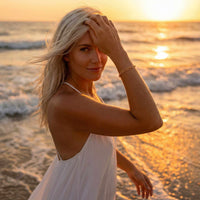 Thumbnail for Woman wearing a Paperclip Chain Bracelet by Brother & Sisters at sunset on the beach.