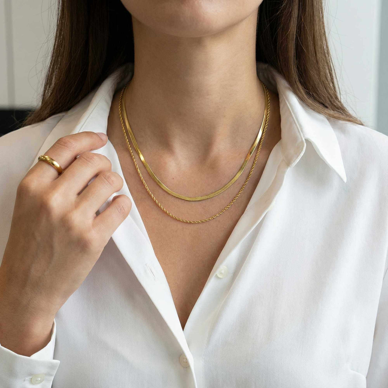 The Double Luxe necklace worn by a woman, showcasing layered gold chains by Brother & Sisters.