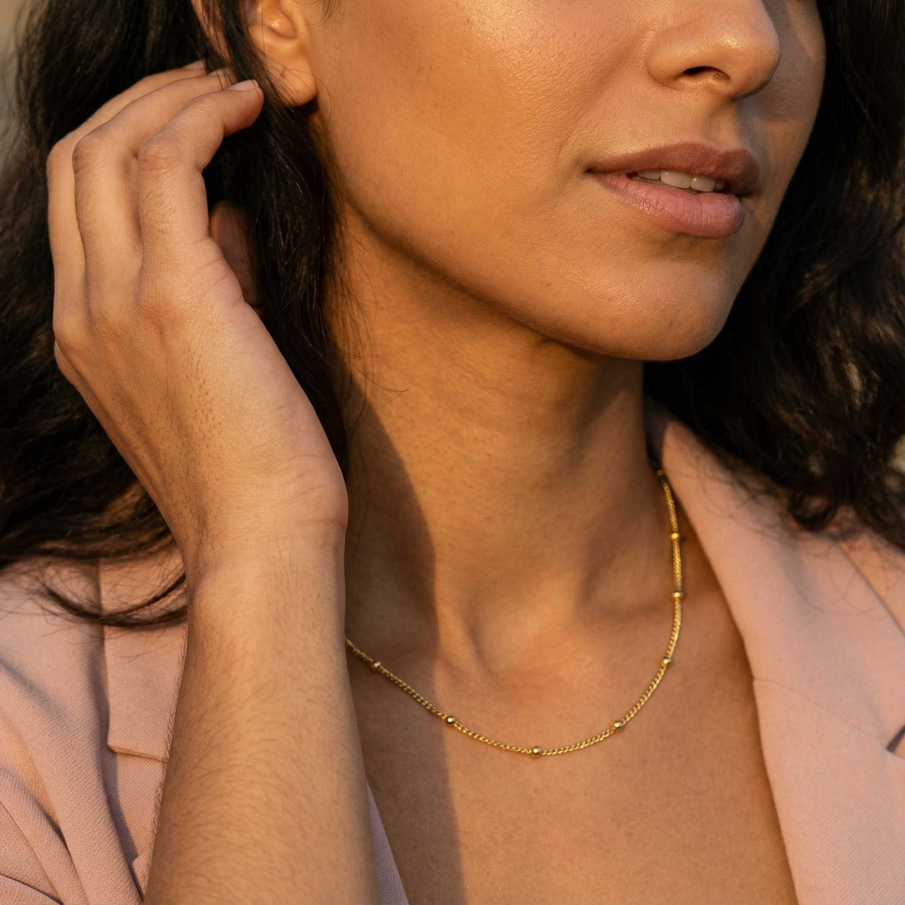 Model wearing Julia Beaded Chain Necklace by Brother & Sisters, showcasing the delicate golden beads and elegant design.